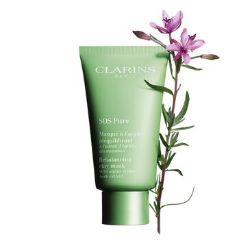 The Clarins SOS Pure Rebalancing Clay Mask Bottle featured alongside a flower.